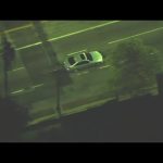 Aerial view of a car on a city street.