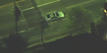 Aerial view of a car on a city street.