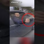 Man sprays water from car window at cyclist