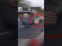 Man sprays water from car window at cyclist