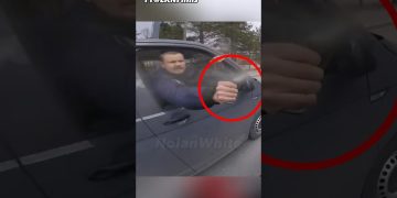 Man sprays water from car window at cyclist