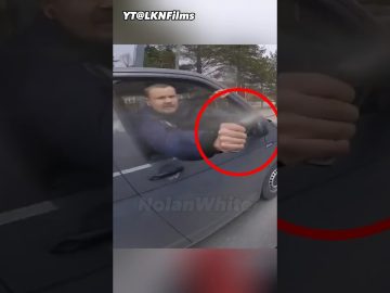 Man sprays water from car window at cyclist