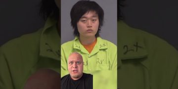 Person in green jumpsuit and another person talking.