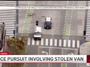 Police chase involving stolen van on city street.