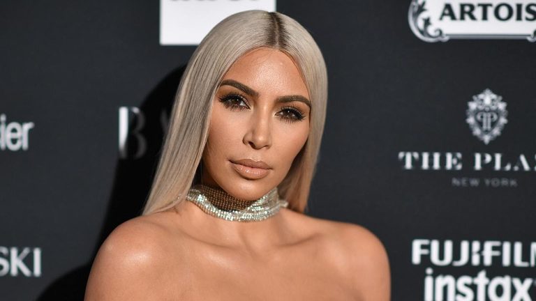 Person at fashion event with jewelry and blonde hair.