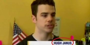 Man interviewed with USA flag background.