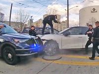 Police officers surrounding a car during a standoff.