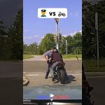 Police officer stops motorcyclist at intersection