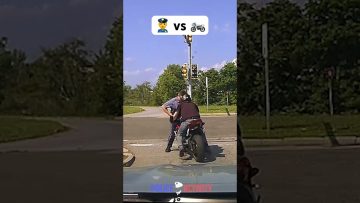 Police officer stops motorcyclist at intersection