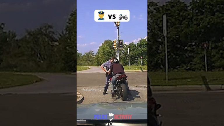 Police officer stops motorcyclist at intersection