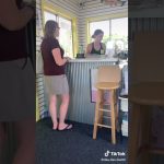 Two women talking at a small business counter