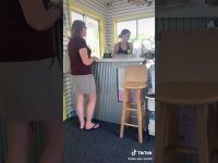 Two women talking at a small business counter