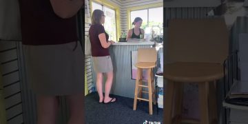Two women talking at a small business counter