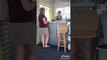 Two women talking at a small business counter