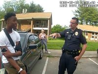 Police officer talking to man by car