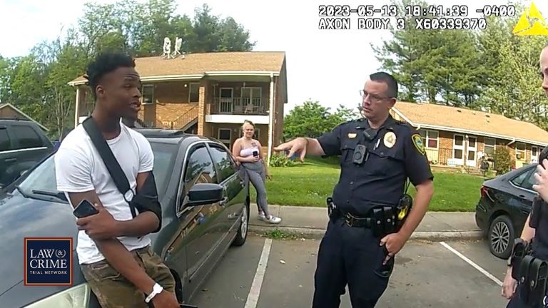 Police officer talking to man by car