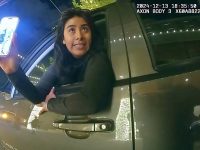 Woman leaning out car window at night