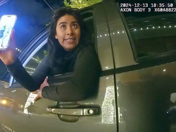 Woman leaning out car window at night