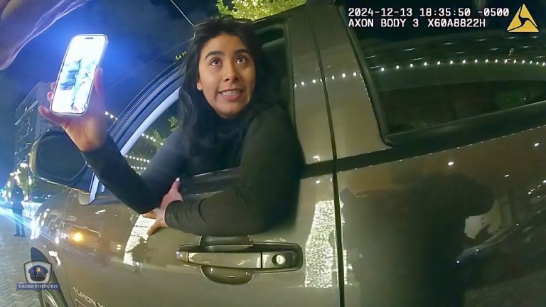 Woman leaning out car window at night