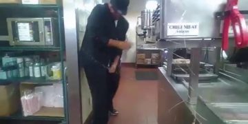 Person working in commercial kitchen spills liquid