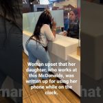 Woman and employee discussing work issue at McDonald's.