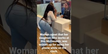 Woman and employee discussing work issue at McDonald's.