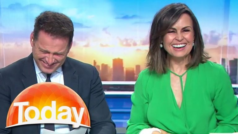 Two TV hosts laughing on morning show set.