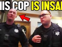 Two police officers in a building.