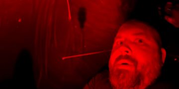 Person in red-lit environment, dramatic lighting.