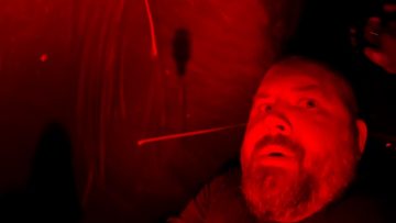 Person in red-lit environment, dramatic lighting.