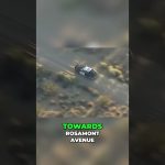 Police car driving off-road towards Rosamont Avenue.