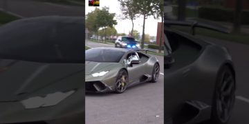 Green sports car followed by police vehicle.