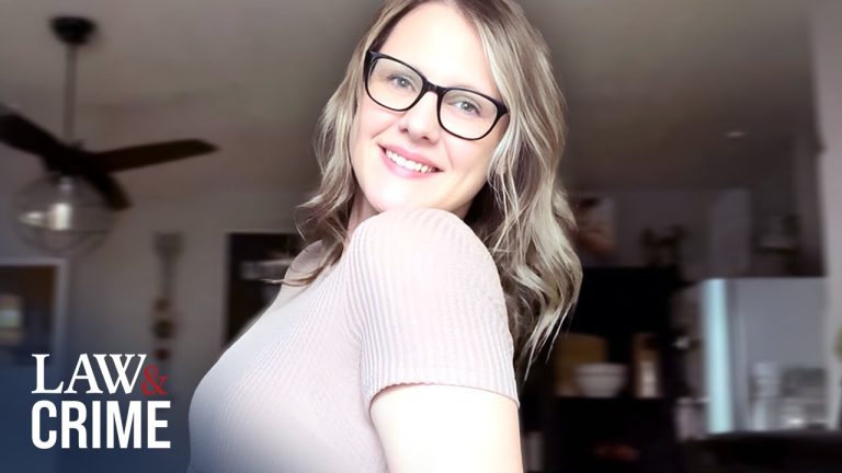 Smiling woman wearing glasses indoors.