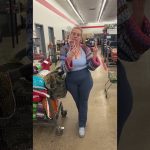 Person in store with shopping cart and phone