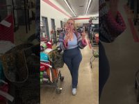 Person in store with shopping cart and phone