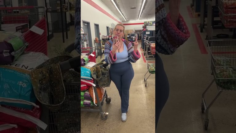 Person in store with shopping cart and phone