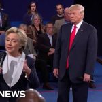 Politicians speaking during debate with audience behind them.