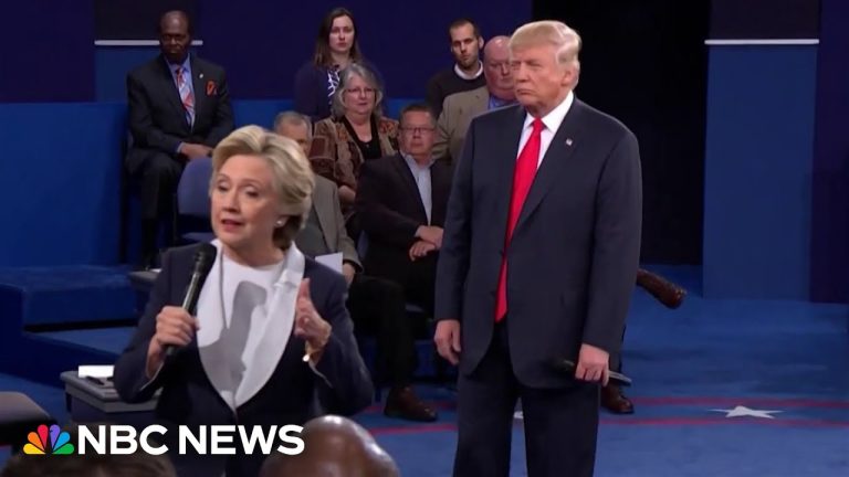 Politicians speaking during debate with audience behind them.