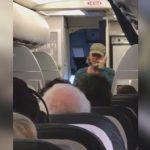 Person speaking on phone during flight.