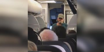 Person speaking on phone during flight.