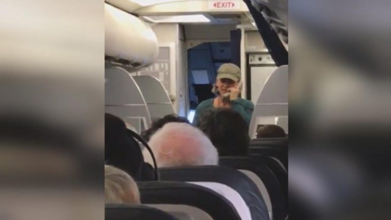 Person speaking on phone during flight.