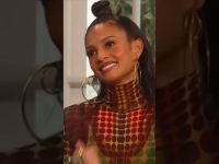 Smiling woman with geometric patterned outfit.