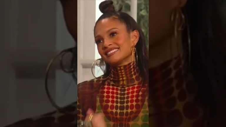 Smiling woman with geometric patterned outfit.