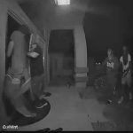 Nighttime door camera footage of attempted break-in.