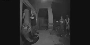 Nighttime door camera footage of attempted break-in.