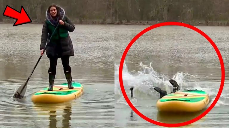 Woman paddleboarding, falling into water