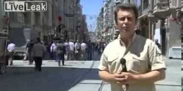 Reporter on busy city street with microphone