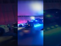 Police cars with flashing lights at night.