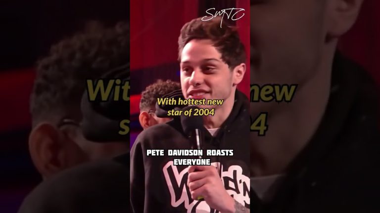 Comedian on stage with microphone, humorous roasting.