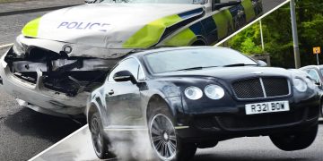 Black car speeds past damaged police vehicle.